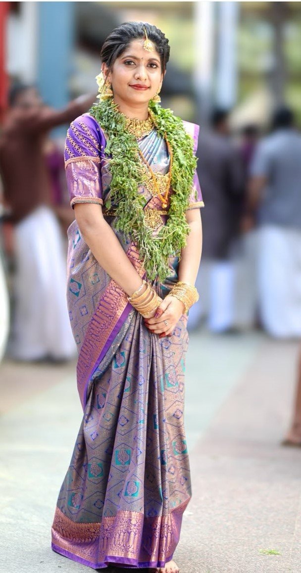 Guruvayur bridal makeup and saree draping - bride in blue and purple silk saree with tulasi garland