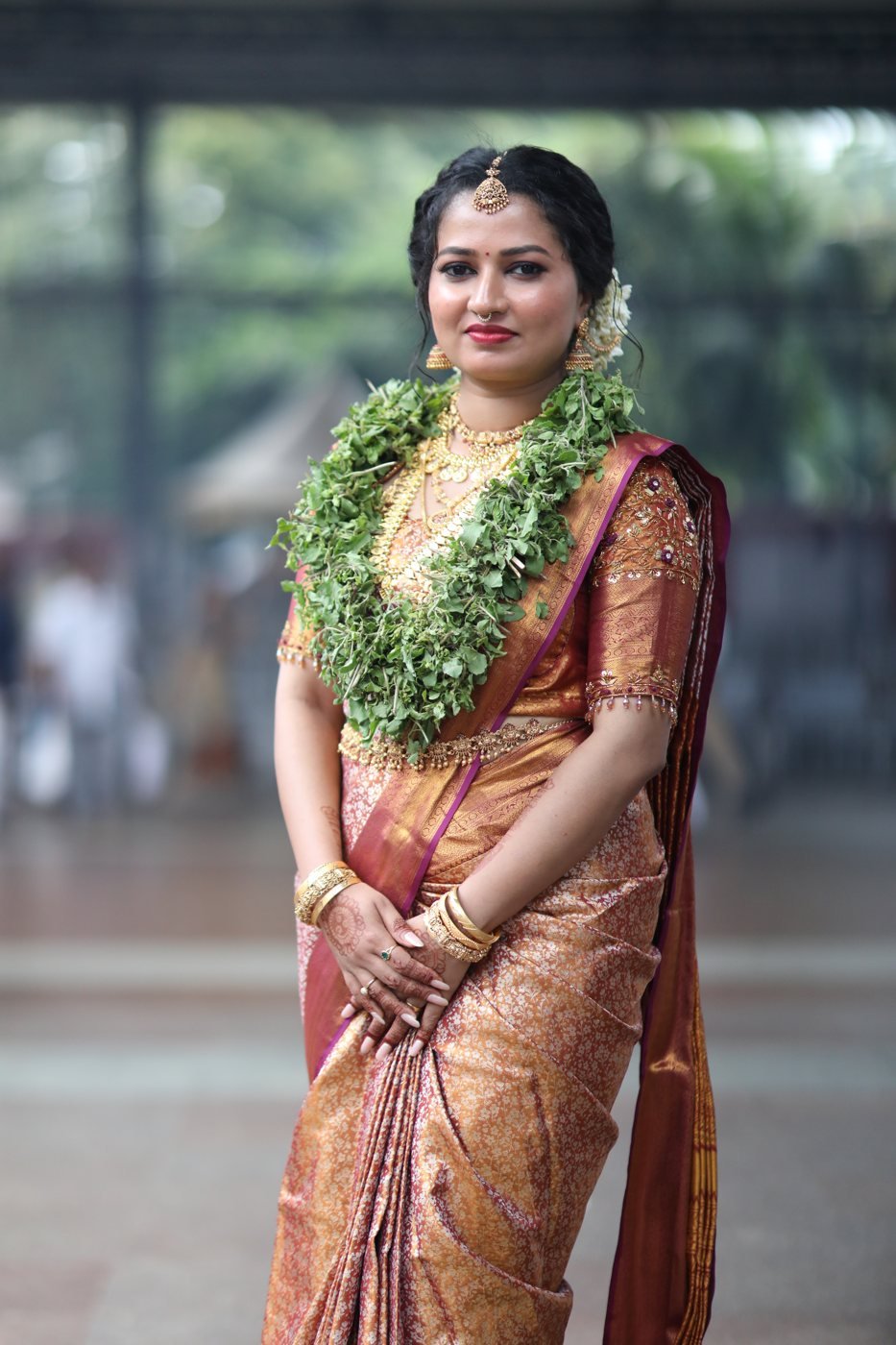 Bridal makeup Guruvayur - bride in copper Kanjivaram saree with tulasi garland and jasmine