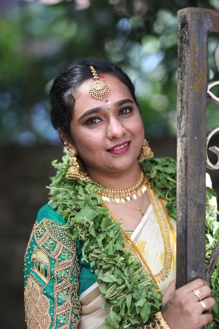 Makeup artist in Guruvayur - bride in green blouse and kasavu saree with tulasi garland