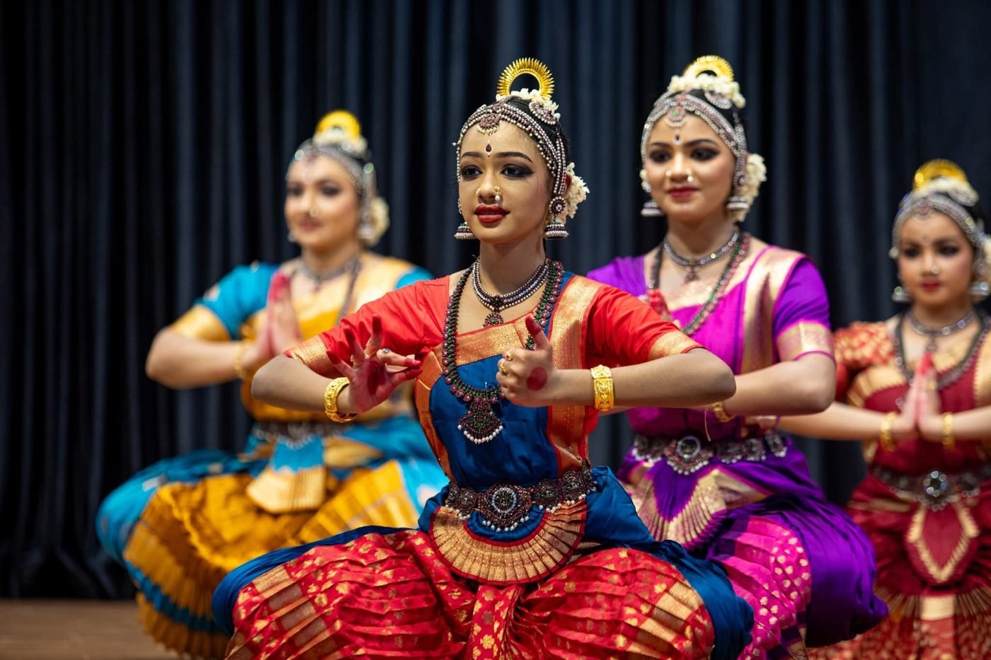 Dance school group makeup Guruvayur - four Bharatanatyam dancers on stage