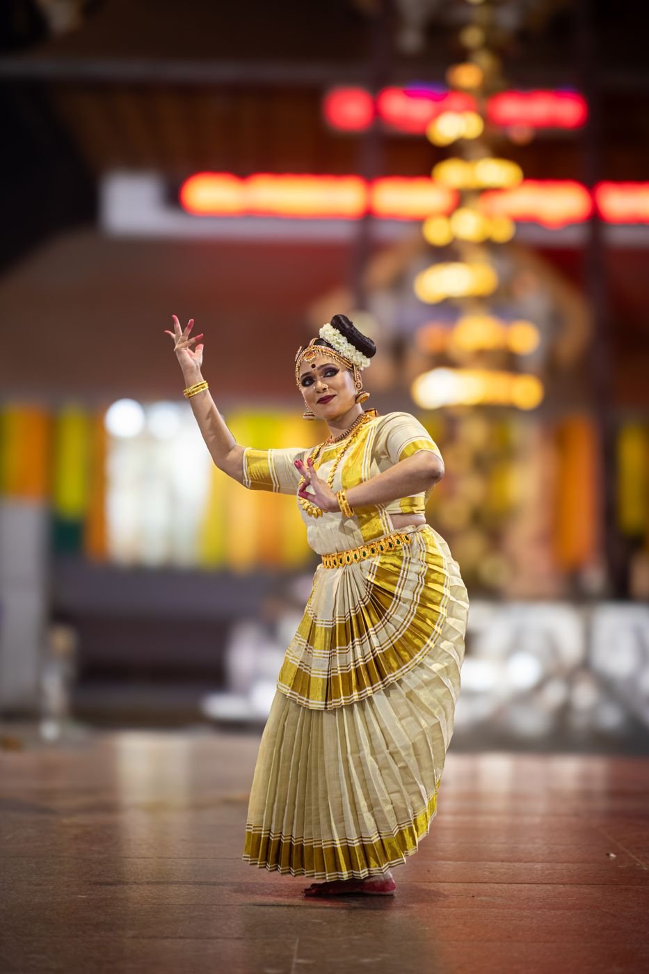 Mohiniyattam stage performance - dancer in kasavu costume on temple stage