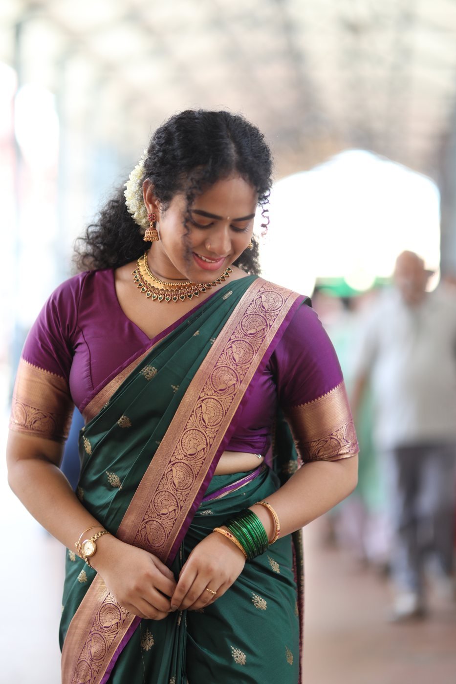 Guest hair and makeup Guruvayur - curly hair with jasmine, green silk saree and kasavu jewellery